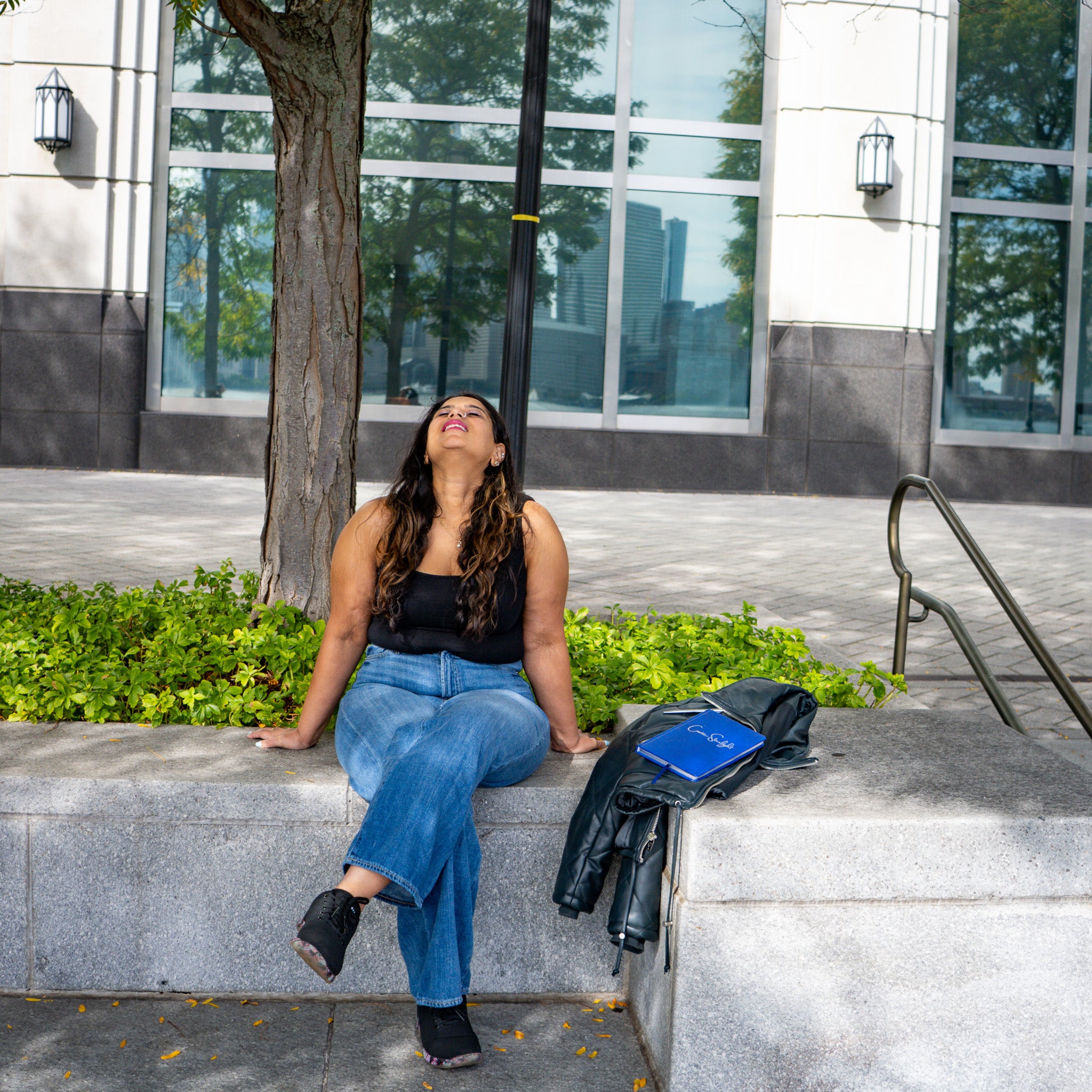 Asmi sitting outside with Cosmic Starlight journal