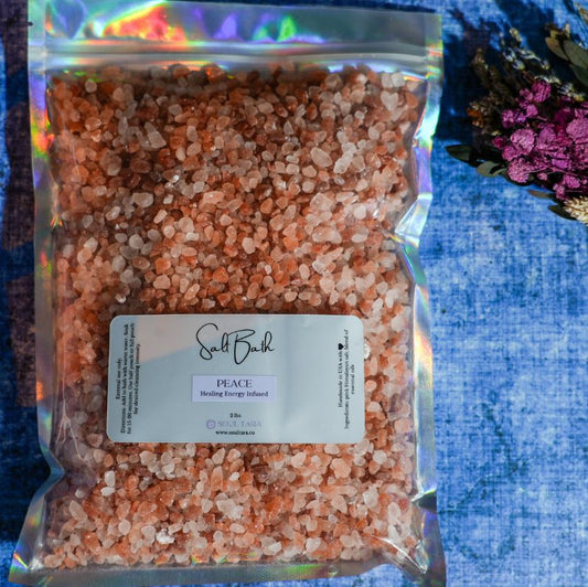 Bag of pink Himalayan salt with a label on a blue textured background
